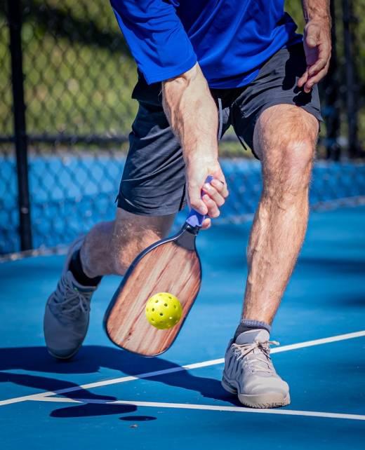 Pickleball,Player,His,A,Low,Volley,Using,A,Forehand,Shot